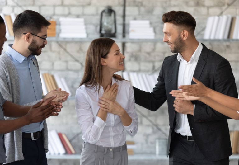 Smiling businessmen congratulate member of the team after successful negotiation