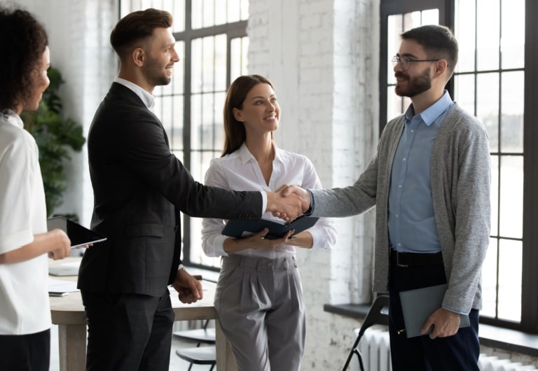 Smiling businessmen handshake close deal or make agreement after successful negotiation
